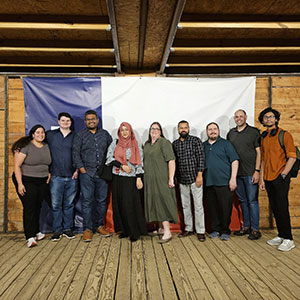 The team gathered for a group photo in front of the Texas flag during our 2025 meetup.
